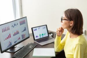 Blog 8 Caucasian advisor financial business analytics woman with data dashboard graphs